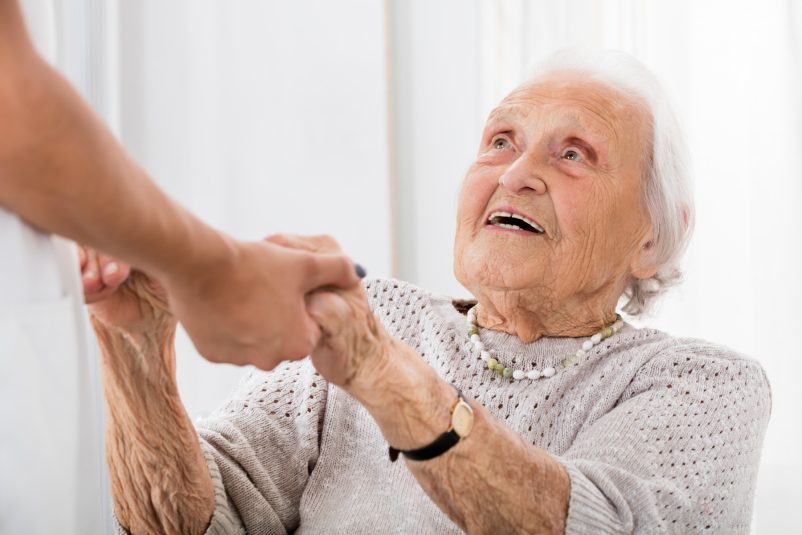 senior-patient-holding-hands-of-female-doctor_0